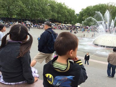 Kids looking at the International Fountain at the Seattle Center, one of the water activities in Seattle for families