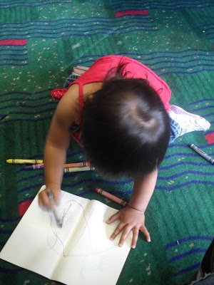 A child coloring during an airport layover with kids