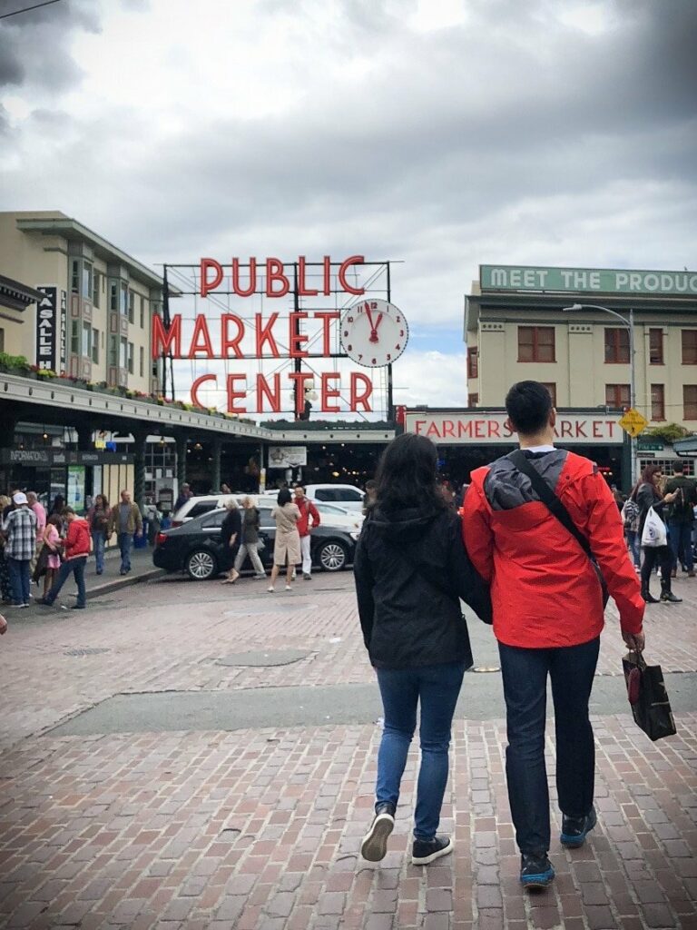 Shoppers walking at Pike Place Market, one of the free things to do in Seattle.