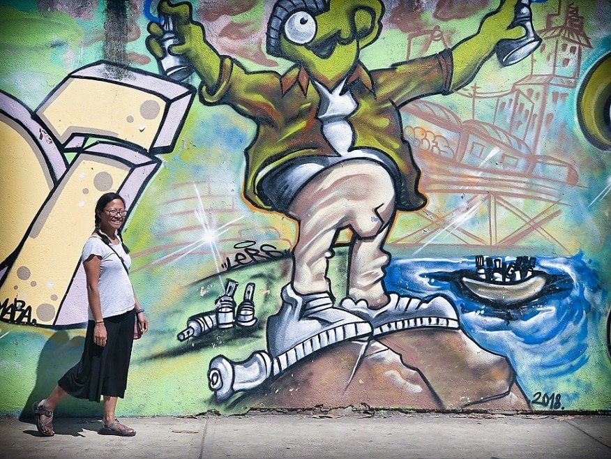 A digital nomad with family exploring street art in Puerto Escondido, Mexico