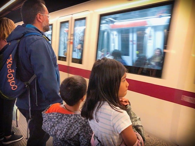 A family riding the subway in Rome, Italy while traveling internationally with kids