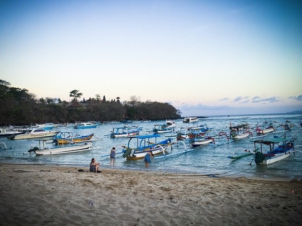 Traditional fishing boats on the water near a beach in Padang Bai in Indonesia, where travelers can visit during a 10 day Bali itinerary