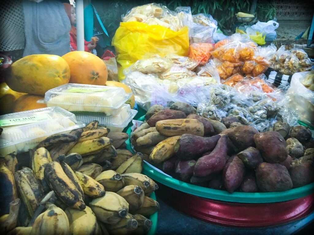Bananas, sweet potatoes, melons, and starchy snacks sold at a Bali night market in Gianyar, Indonesia