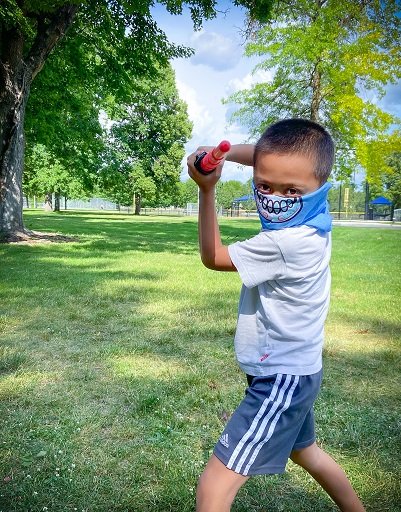 Child wearing tubular bandanas for outdoor playing at the park