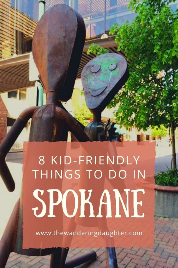 8 Kid-Friendly Things to do in Spokane | The Wandering Daughter 

Pinterest image of a metal sculpture of two figures looking at each other on the sidewalk of a city street. Text overlay.