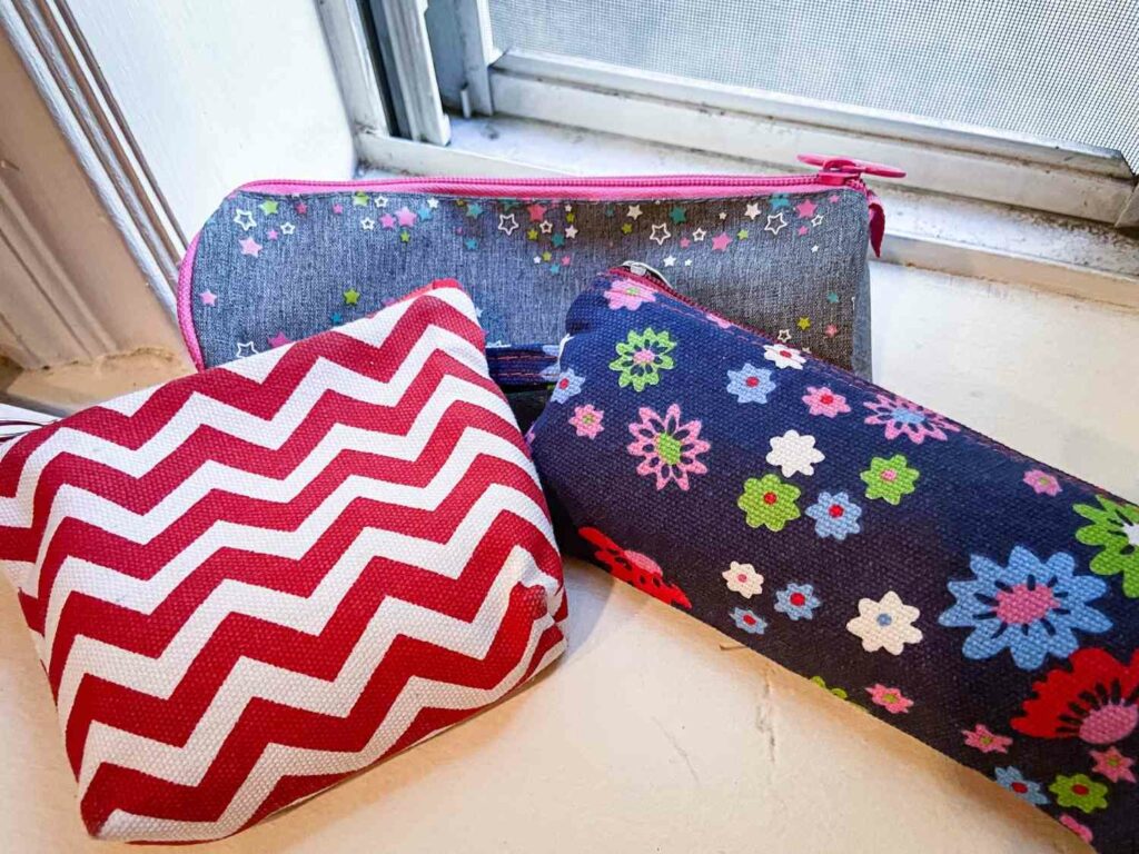 Cloth zipper pouches and eco friendly travel products in assorted colors and patterns