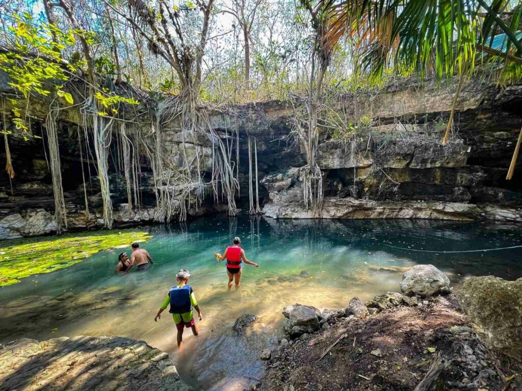 Visitors to a cenote near Merida going off the beaten path in Mexico