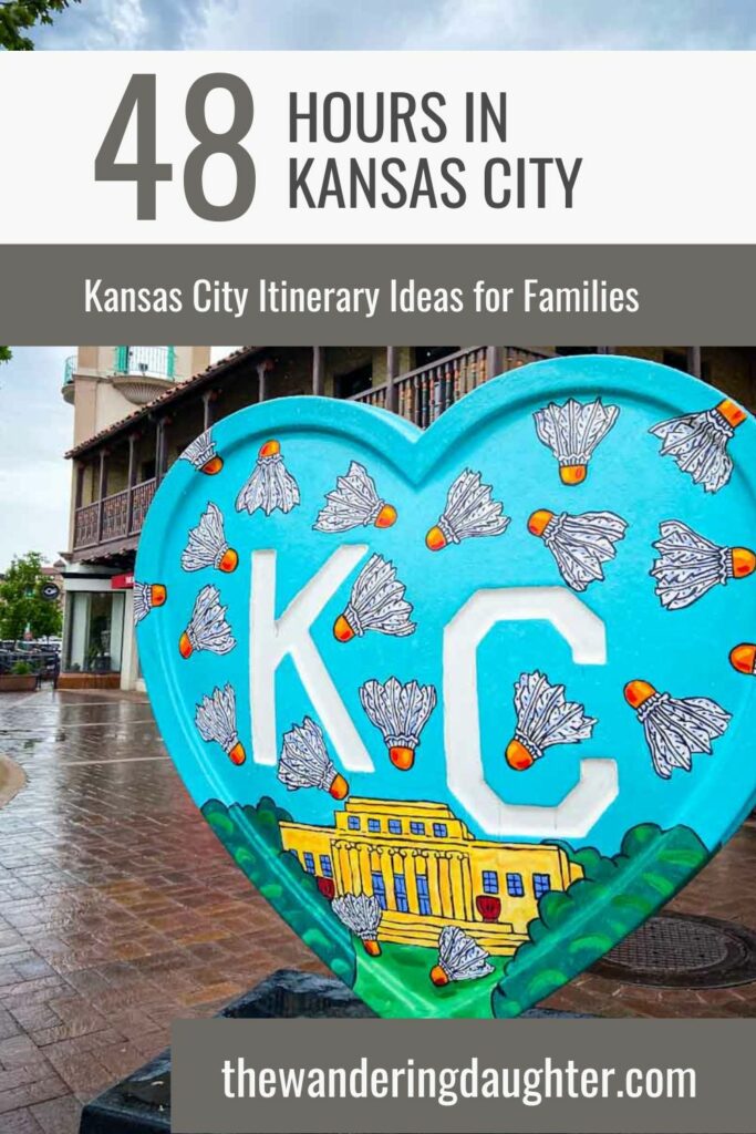 Best 48 Hours In Kansas City Itinerary: 12 Exciting Ideas For Travelers and Families | The Wandering Daughter | Pinterest image of a teal heart with the letters KC and badminton birdies and a yellow building with columns. In the background is a Spanish style building, plus text overlay.