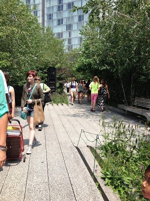 Visitors walking along the concrete sidewalk at The High Line railroad park
