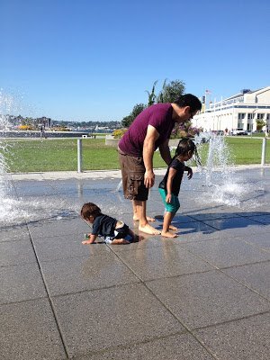 A family playing at the South Lake Union water park, one of the water activities in Seattle that families can do