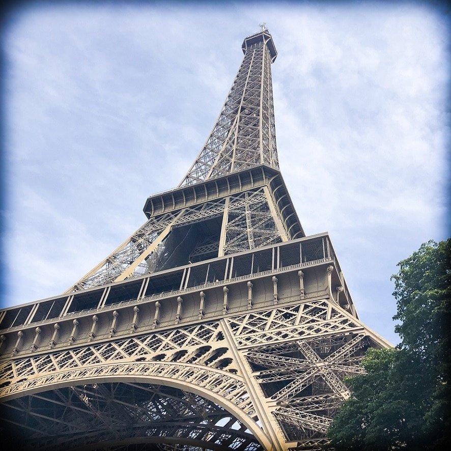 A view of the Eiffel Tower during a Paris 3 day itinerary. The view is from one of the base corners, looking up at the top of the tower.