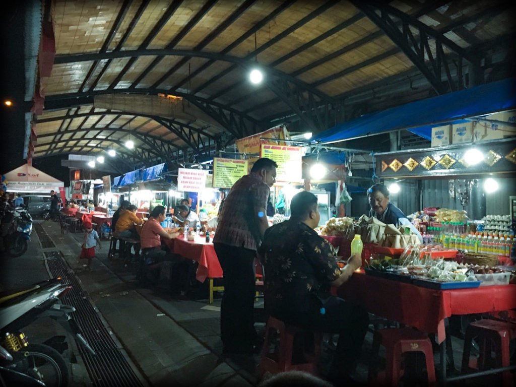 People eating at food stalls at a Bali night market in Gianyar, Indonesia