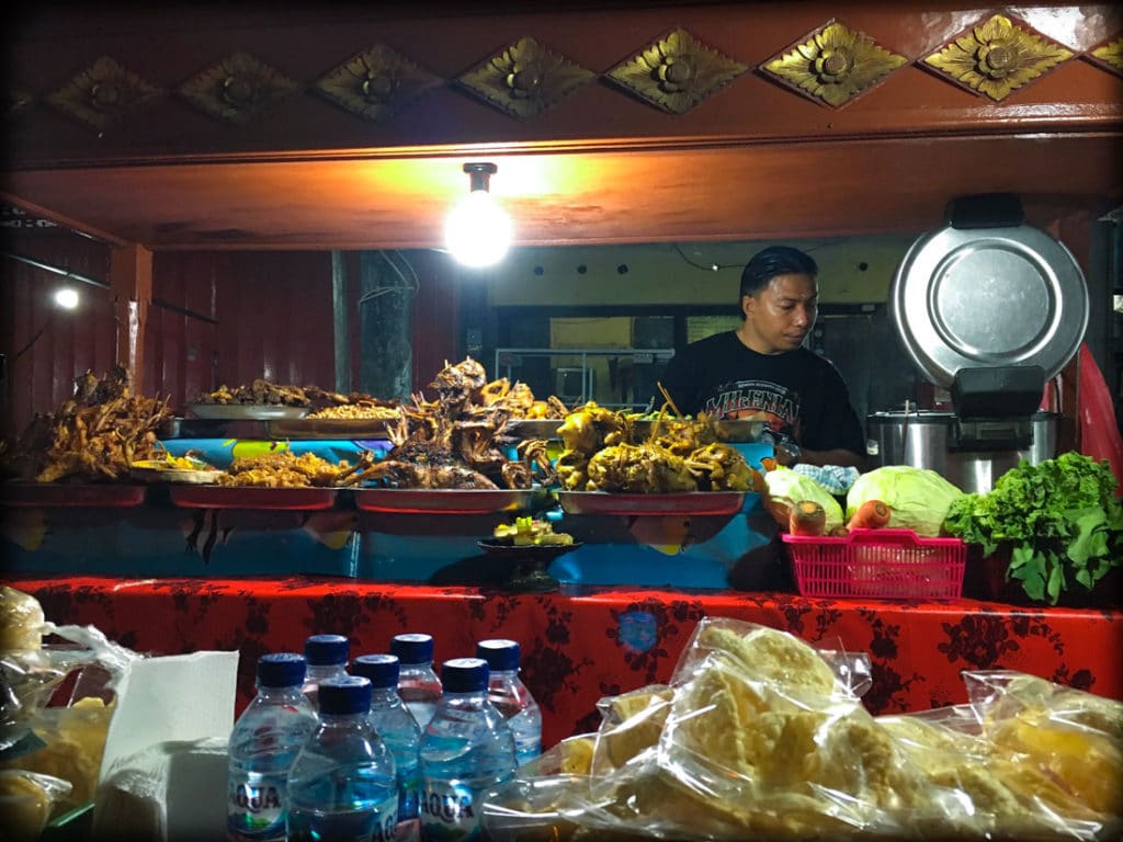 A food stall serving chicken, duck, and goat at a Bali night market in Gianyar, Indonesia