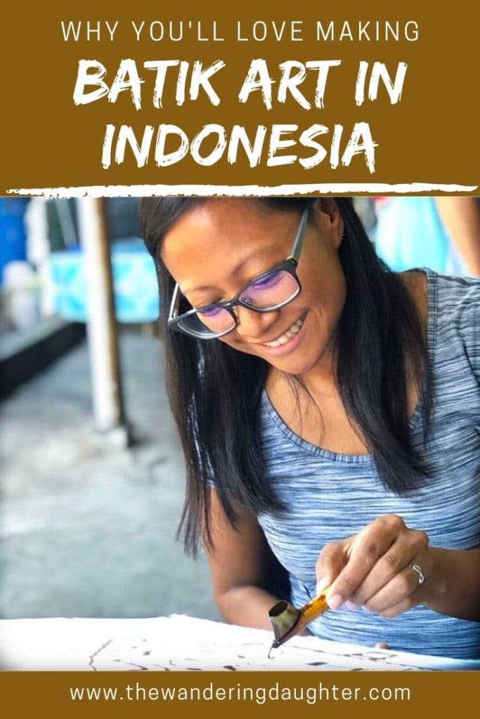 Why You'll Love Making Batik Art in Yogyakarta, Indonesia | The Wandering Daughter | Why families traveling to Yogyakarta, Indonesia will enjoy making batik art. Pinterest image of a woman printing a wax design for batik.