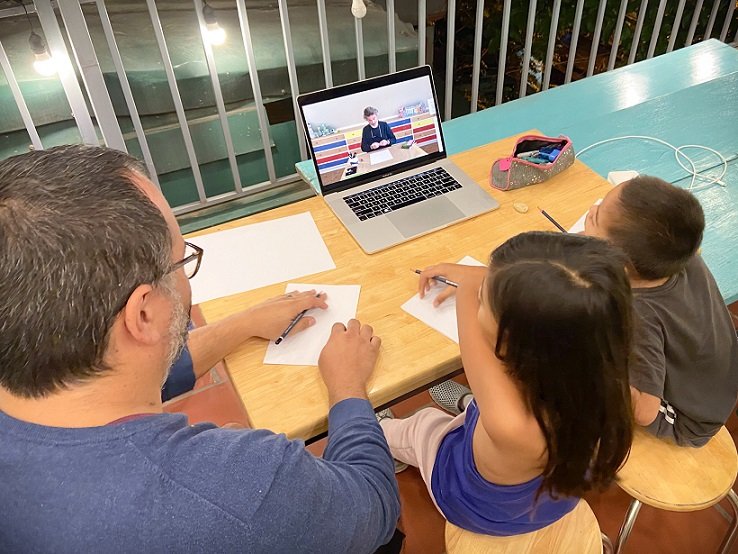 A worldschooling family learning how to draw using an online class