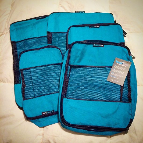 Various sized empty packing cubes for family travel