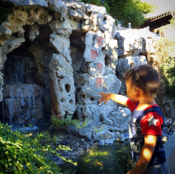 A child exploring Lan Su Chinese Garden in kid friendly Portland