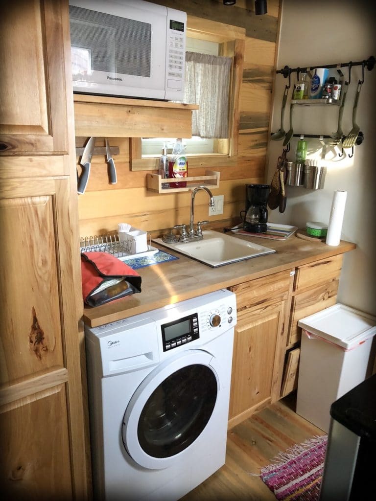 A tiny house kitchen at an Airbnb, an option for families when budgeting for a road trip 