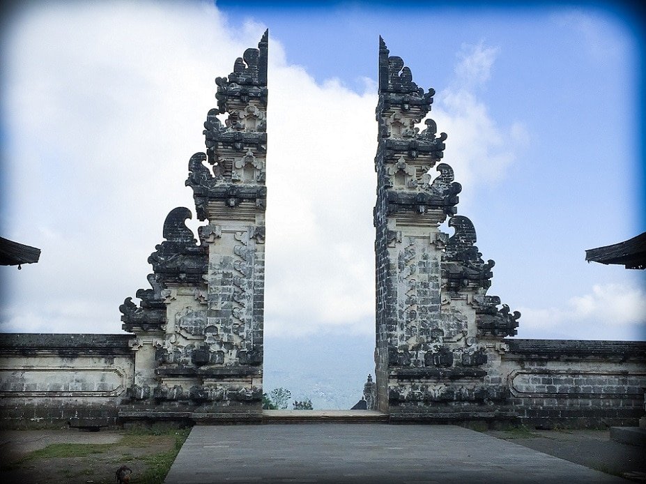 The iconic Gates of Heaven at Pura Lempuyang Temple Bali. Two Balinese temple gates, with the sky in the background.