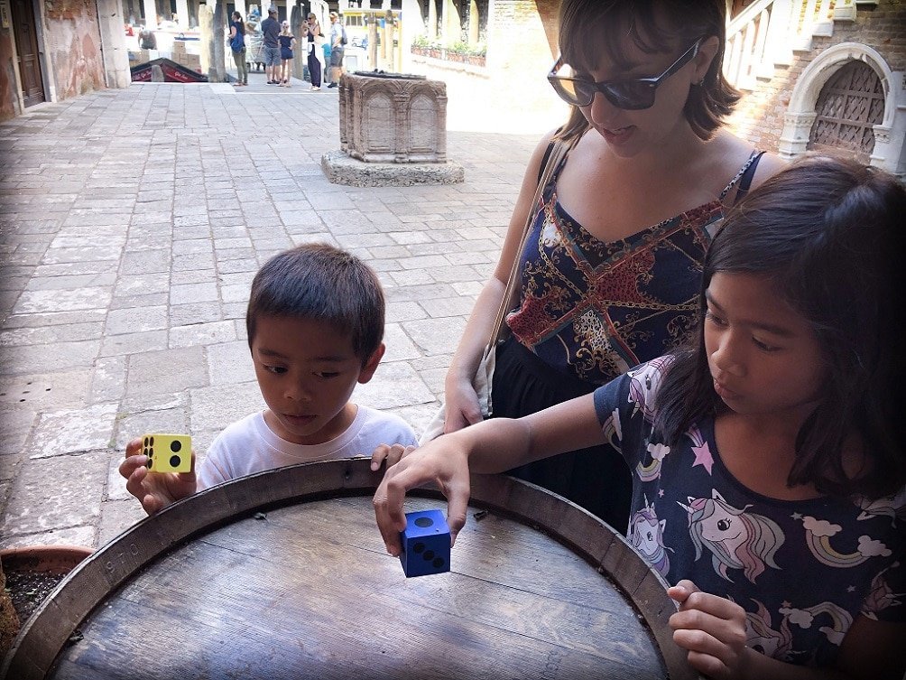 Kids and a tour guide doing game during a family-friendly Venice walking tour