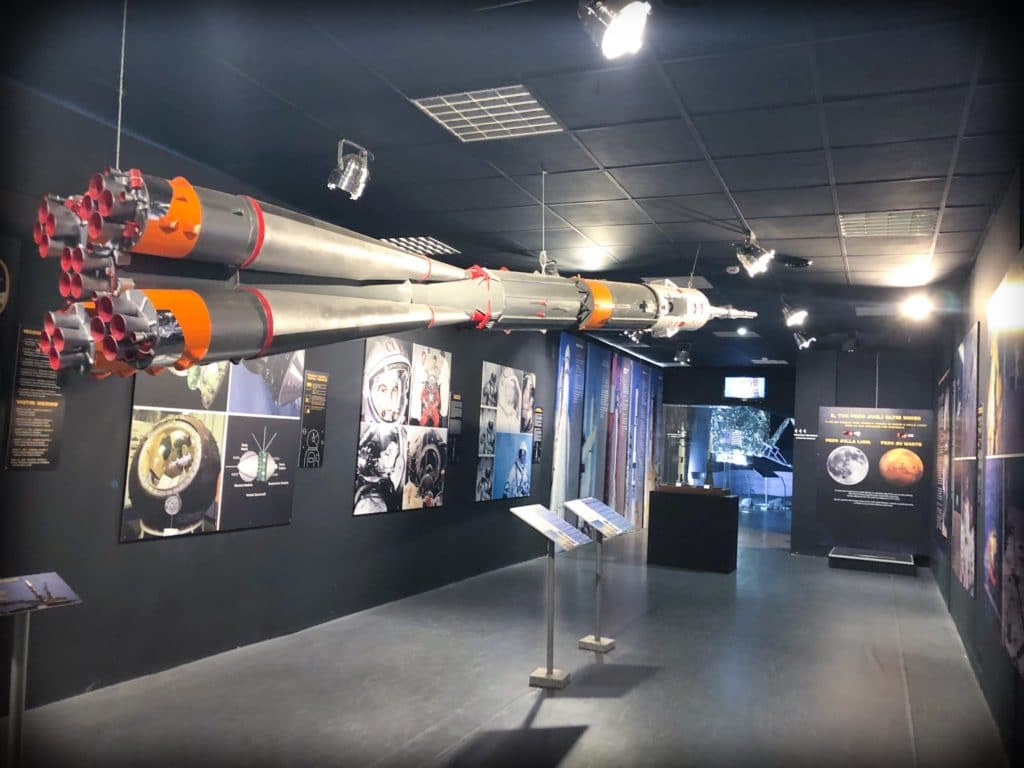 A rocket hanging from the ceiling as part of a space exhibit at a museum of aviation in Milan, Italy.