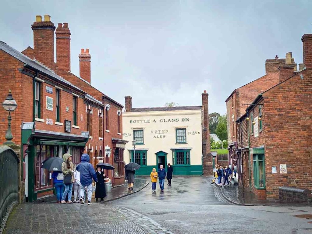 A street with people walking along it at the Black Country Living Museum in Birmingham, one of the places to visit in the West Midlands, UK